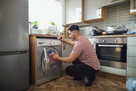 man loading a washing machine