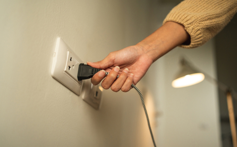 woman plugging into an outlet