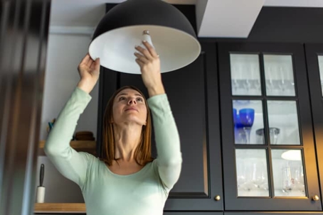 woman changing a lightbulb